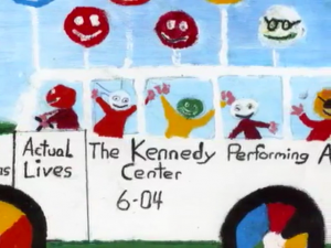 A bright, vibrant painting of a white bus filled with happy, multicolored people and smiling faces on top of the bus. On the side of the bus is "Actual Lives. The Kennedy Performing Arts Center 6-04".