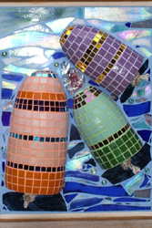 A 3-D glass mosaic of three multi-colored buoys floating in the ocean.