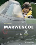 The cover of "Welcome to Marwencol" shows Hogie in a fighter jet wearing headphones and a life vest. He stares directly at the camera.