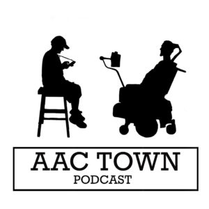 AAC Town Logo: the words “AAC Town Podcast” surrounded by a rectangle, with a silhouette on either end: one person wearing a baseball cap and sitting on a chair with their iPad, and the other person sitting in a wheelchair with communication device mounted in front.